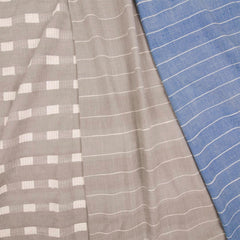Three overlapping draped woven fabrics with delicate striped patterns in light gray and blue.