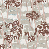 Detail of wallpaper in a painterly palm tree print in shades of pink, brown and blue on a white field.