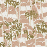 Detail of fabric in a painterly palm tree print in shades of pink, beige and olive on a white field.