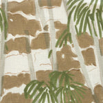 Close-up of fabric in a painterly palm tree print in shades of green, gray and brown on a white field.