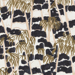 Detail of fabric in a painterly palm tree print in shades of gold, beige and navy on a white field.