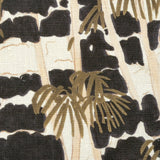 Close-up of fabric in a painterly palm tree print in shades of gold, beige and navy on a white field.