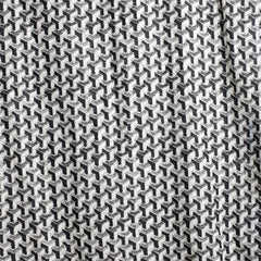 Fabric swatch with a graphic interlocking square pattern in shades of black, white and gray.