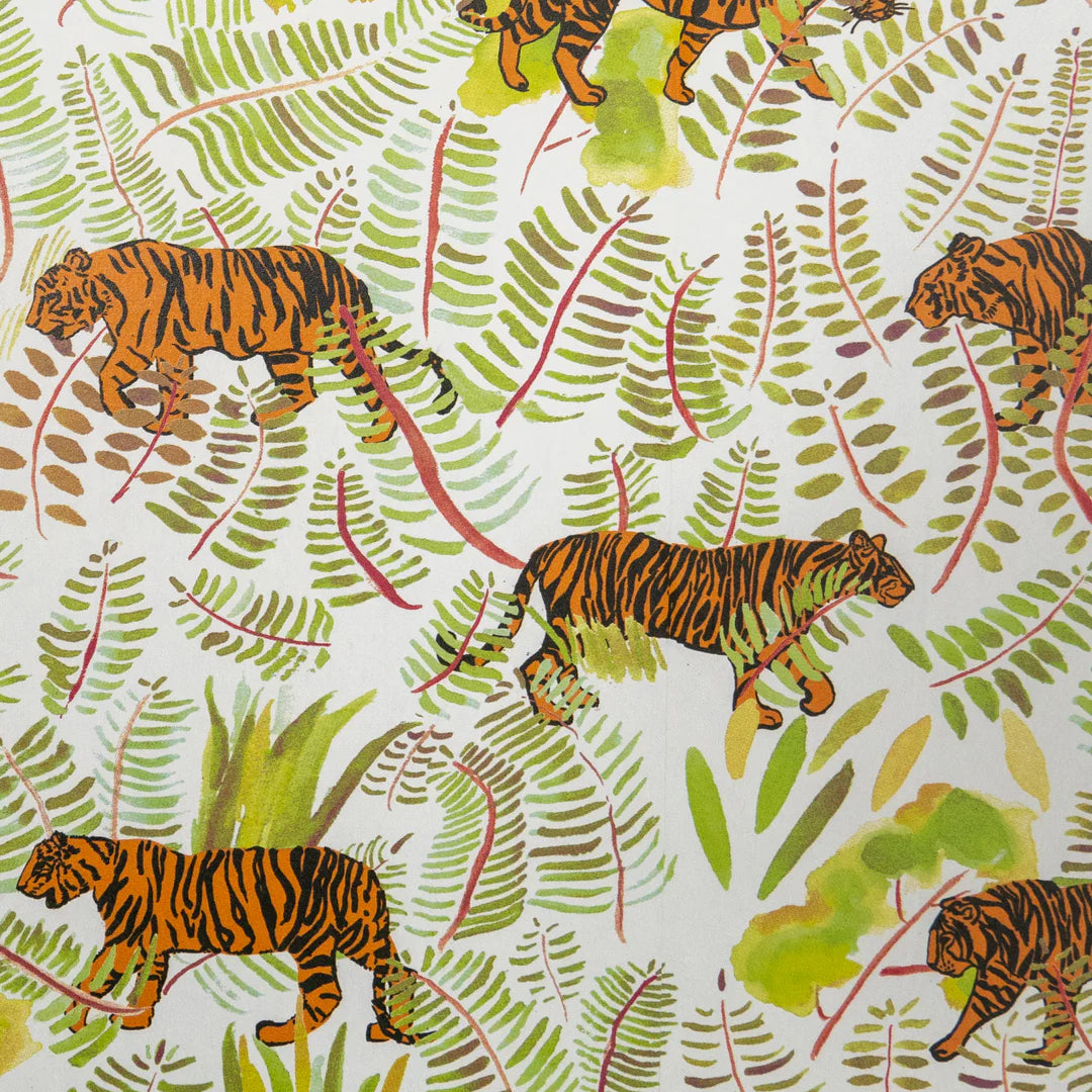 Detail of wallpaper in a playful tiger and leaf print in shades of green, orange and black on a white field.