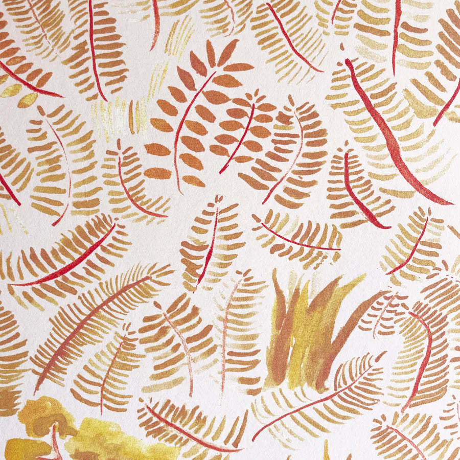 Detail of wallpaper in a playful leaf print in shades of yellow and orange on a white field.