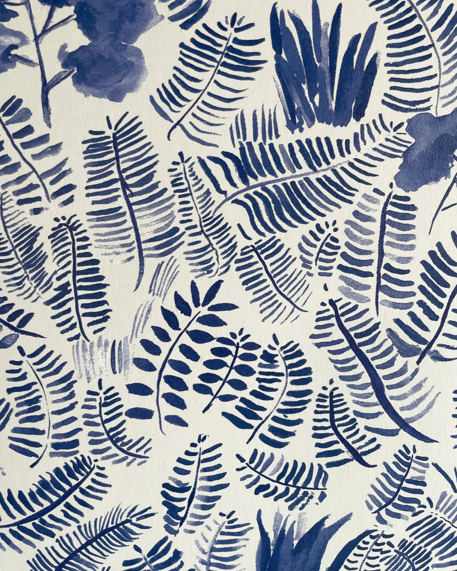 Detail of wallpaper in a playful leaf print in shades of blue on a cream field.