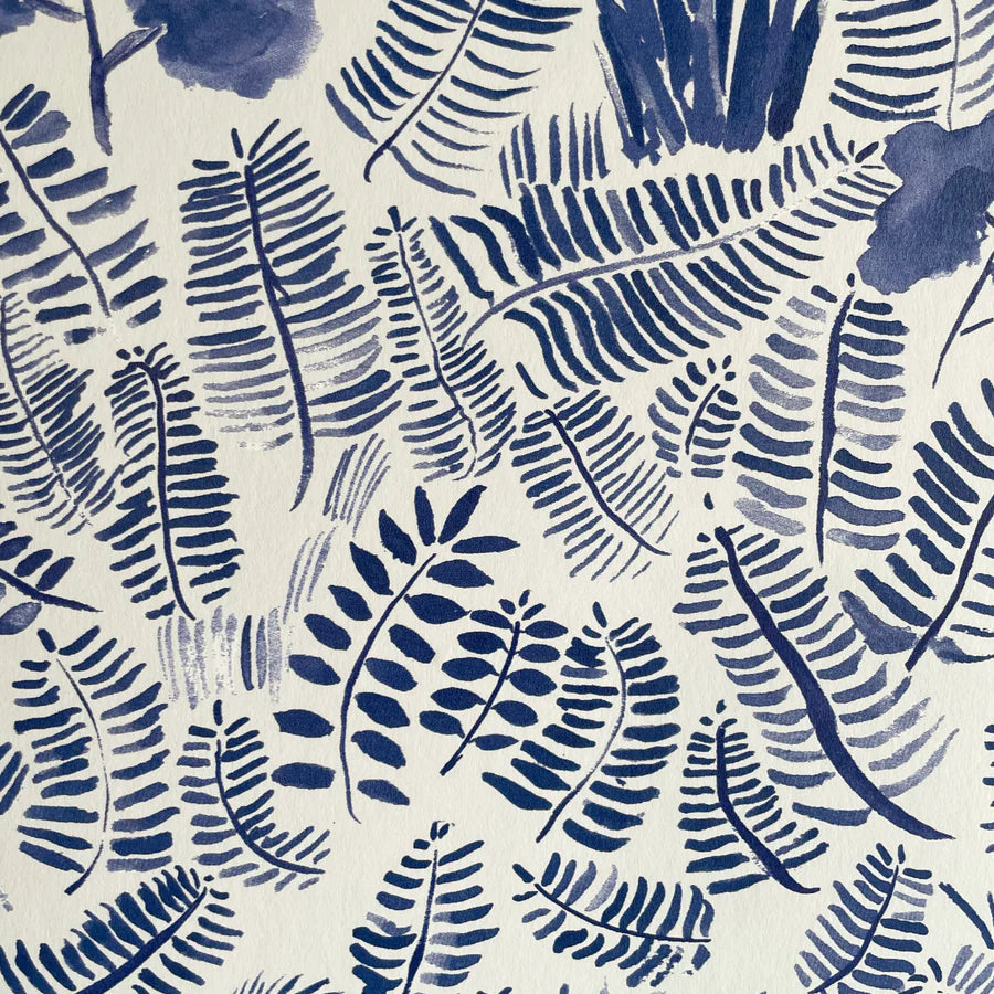 Detail of wallpaper in a playful leaf print in shades of blue on a cream field.