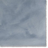 Detail of a hand-painted wallpaper swatch in blue gray with an irregular brushed texture.