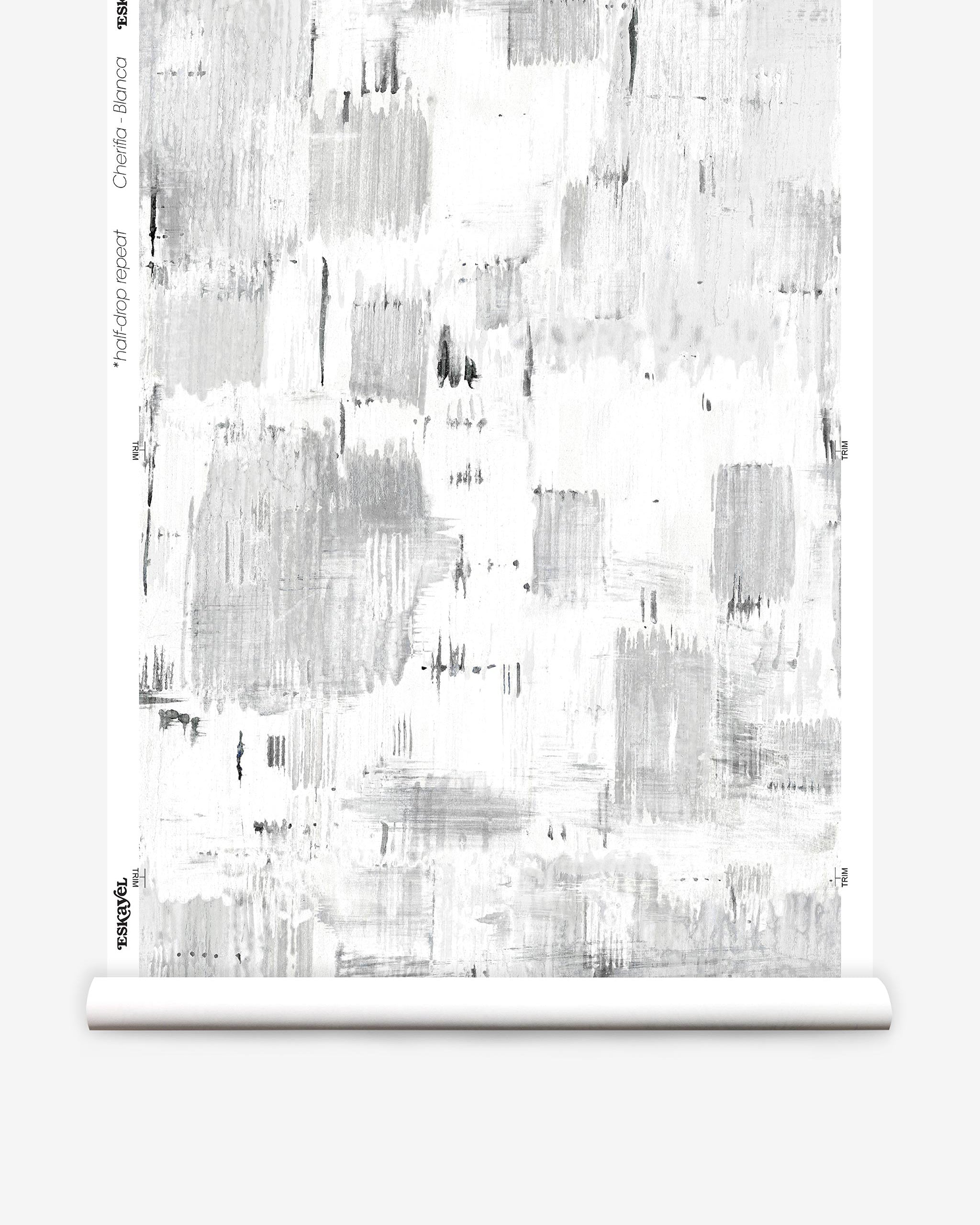 Partially unrolled wallpaper yardage in an abstract textural print in shades of gray on a white field.