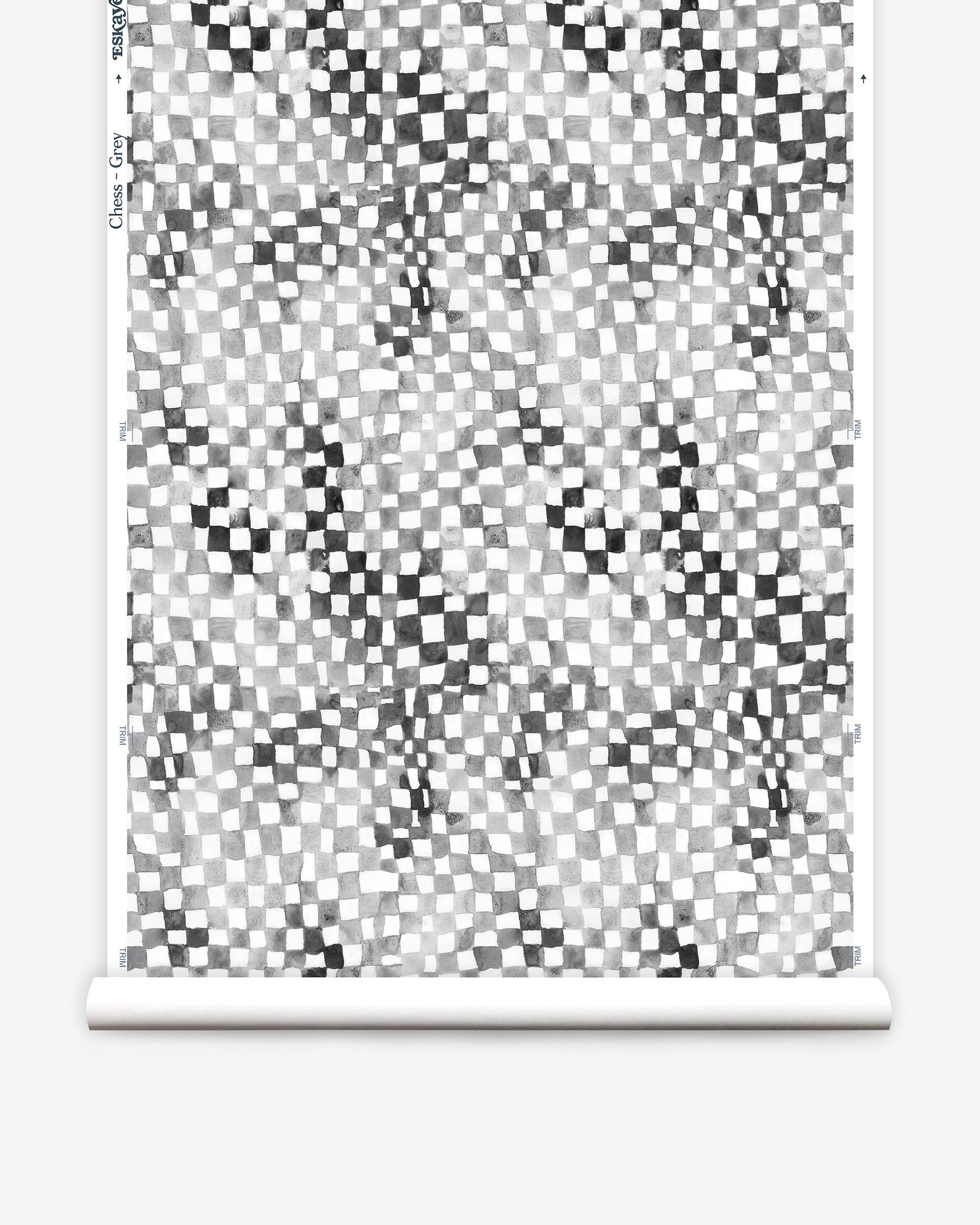 Partially unrolled wallpaper yardage in a painterly chess board print in gray, black and white.