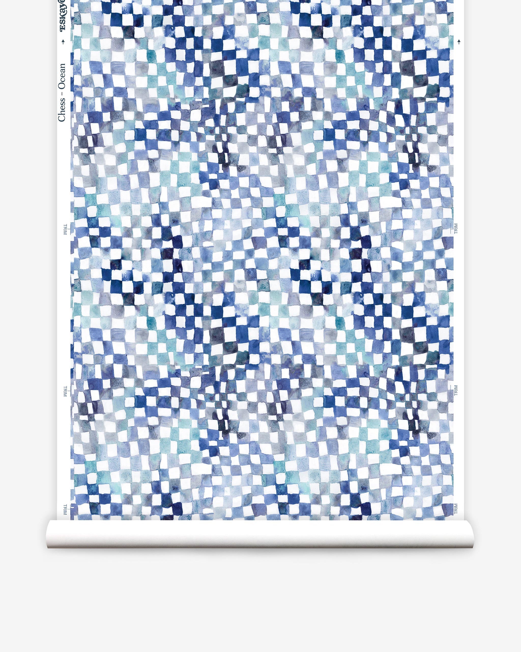 Partially unrolled wallpaper yardage in a painterly chess board print in shades of blue, navy and white.