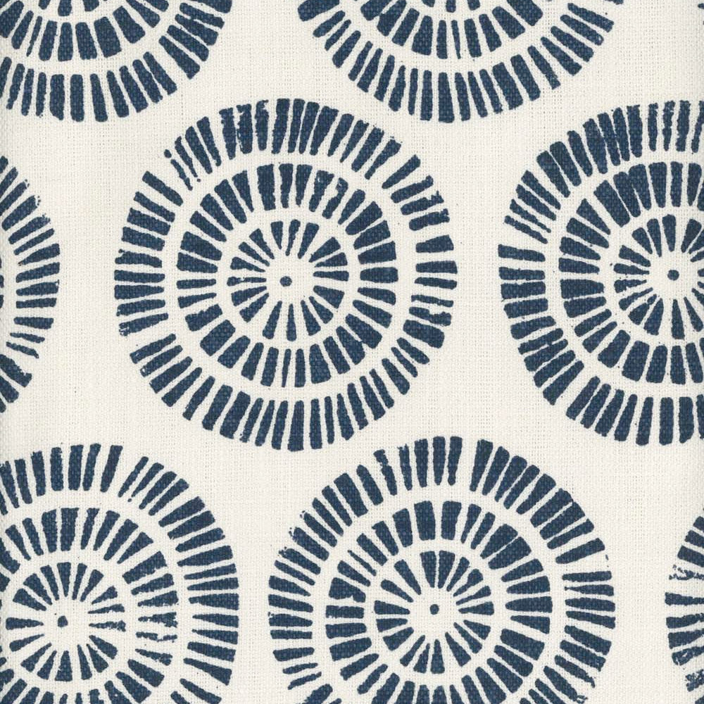 Detail of fabric in a geometric wheel print in navy on a white field.