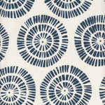 Detail of fabric in a geometric wheel print in navy on a white field.