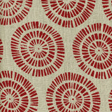 Detail of fabric in a geometric wheel print in red on a tan field.