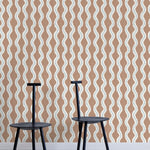 Two minimalist black chairs stand in front of a wall papered in a playful curvy stripe print in white, blue and brown.