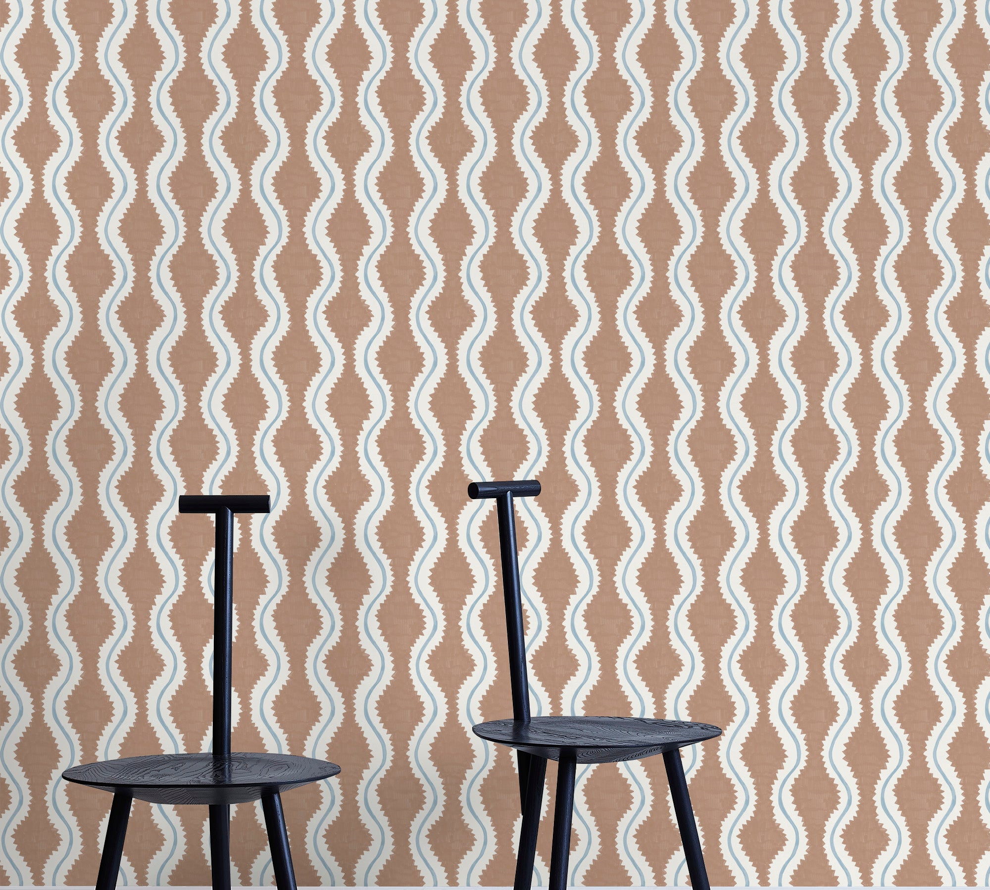 Two minimalist black chairs stand in front of a wall papered in a playful curvy stripe print in white, blue and brown.