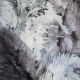 Detail of fabric in a painterly palm leaf print in shades of blue, pink and gray on a cream field.