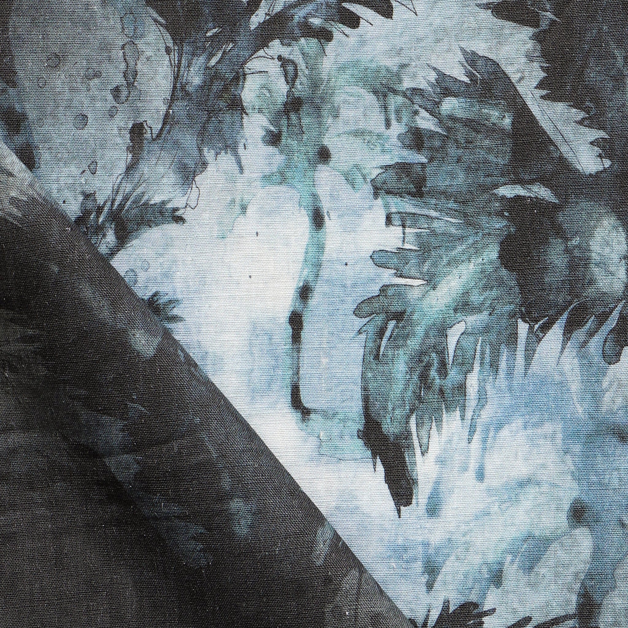 Detail of fabric in a painterly palm leaf print in shades of gray and turquoise on a cream field.