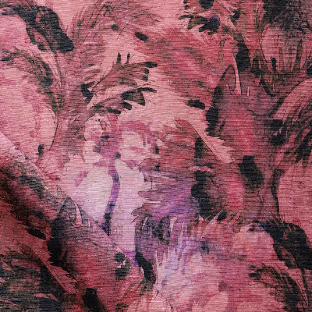 Detail of fabric in a painterly palm leaf print in shades of red, purple and gray.