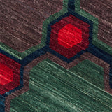 Close-up of a textured surface with red and green geometric patterns