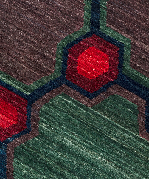 Close-up of a textured surface with red and green geometric patterns