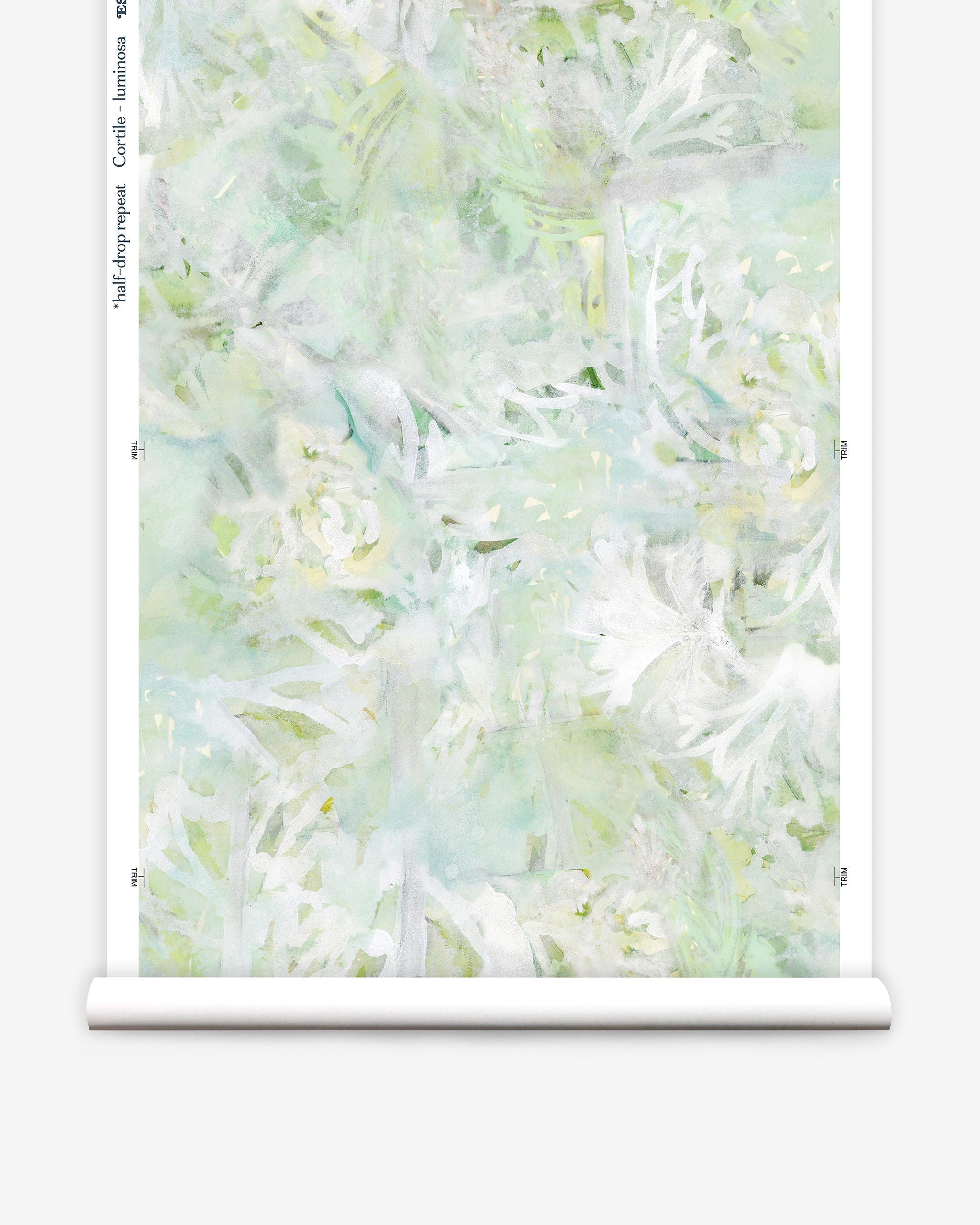 Partially unrolled wallpaper yardage in an abstract painted print in shades of green, yellow and white.