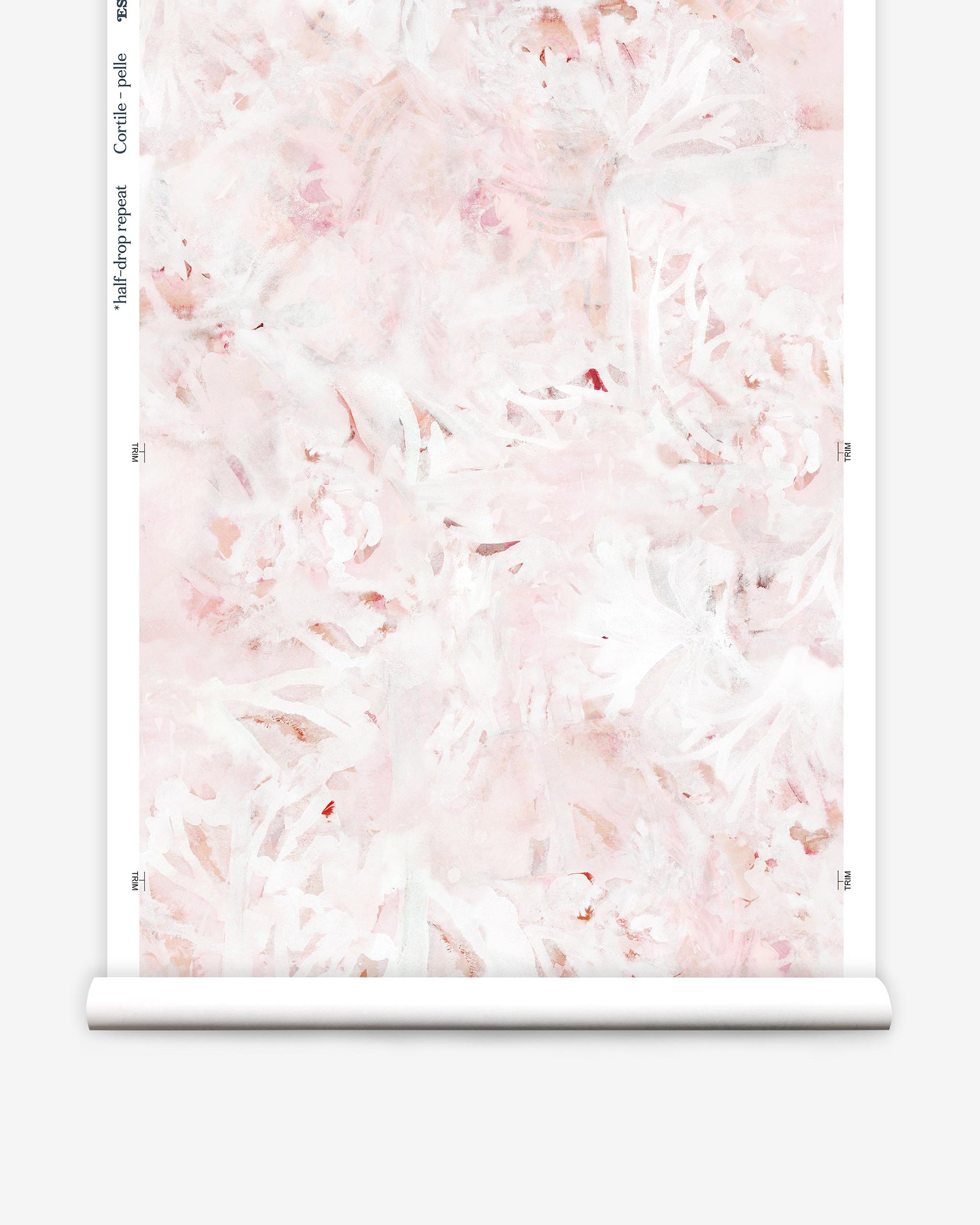 Partially unrolled wallpaper yardage in an abstract painted print in shades of pink, red and white.