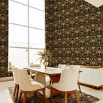 A modernist dining room with a tall window and walls papered in a floral damask print in cream, coral, gold and black.