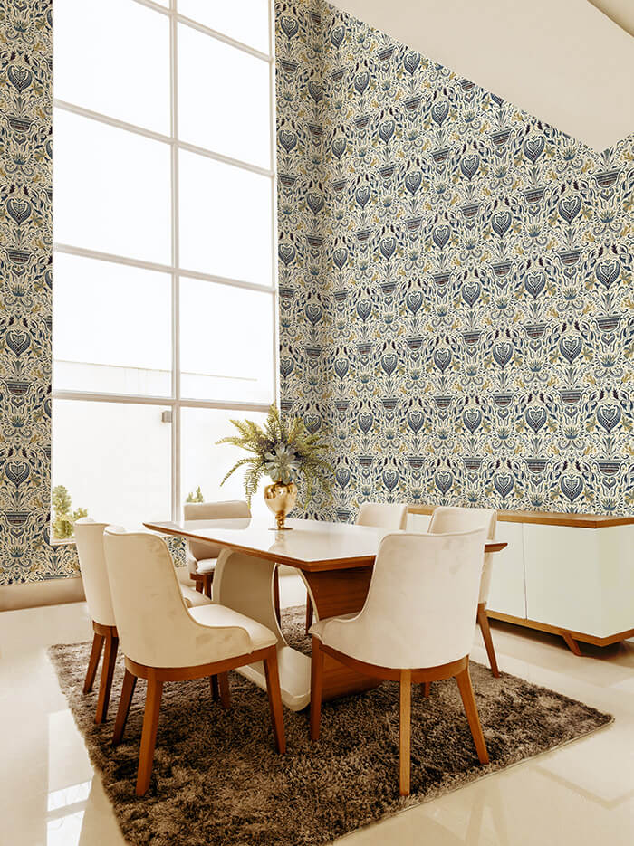 A modernist dining room with a tall window and walls papered in a floral damask print in navy, cream and gold.