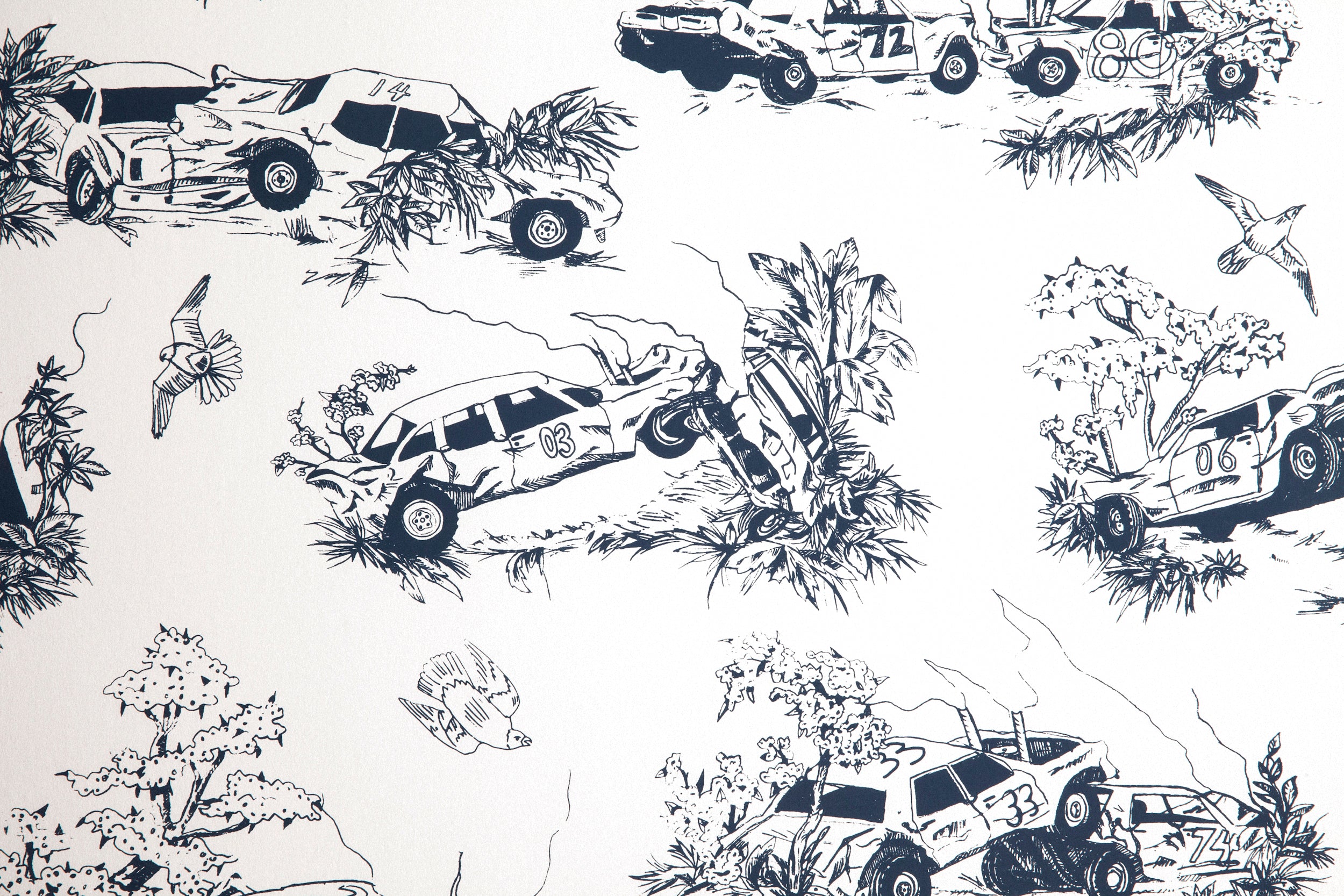 Detail of wallpaper in a playful illustrated car crash print in navy on a white field.