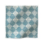 Square fabric swatch in a textural diamond print in blue and cream.