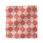 Square fabric swatch in a textural diamond print in red and cream.