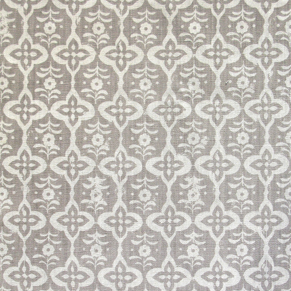 Detail of fabric in a floral grid print in cream on a light gray field.
