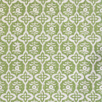 Detail of fabric in a floral grid print in cream on a green field.