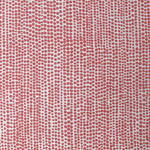 Detail of fabric in a painterly dotted print in coral on a white field.