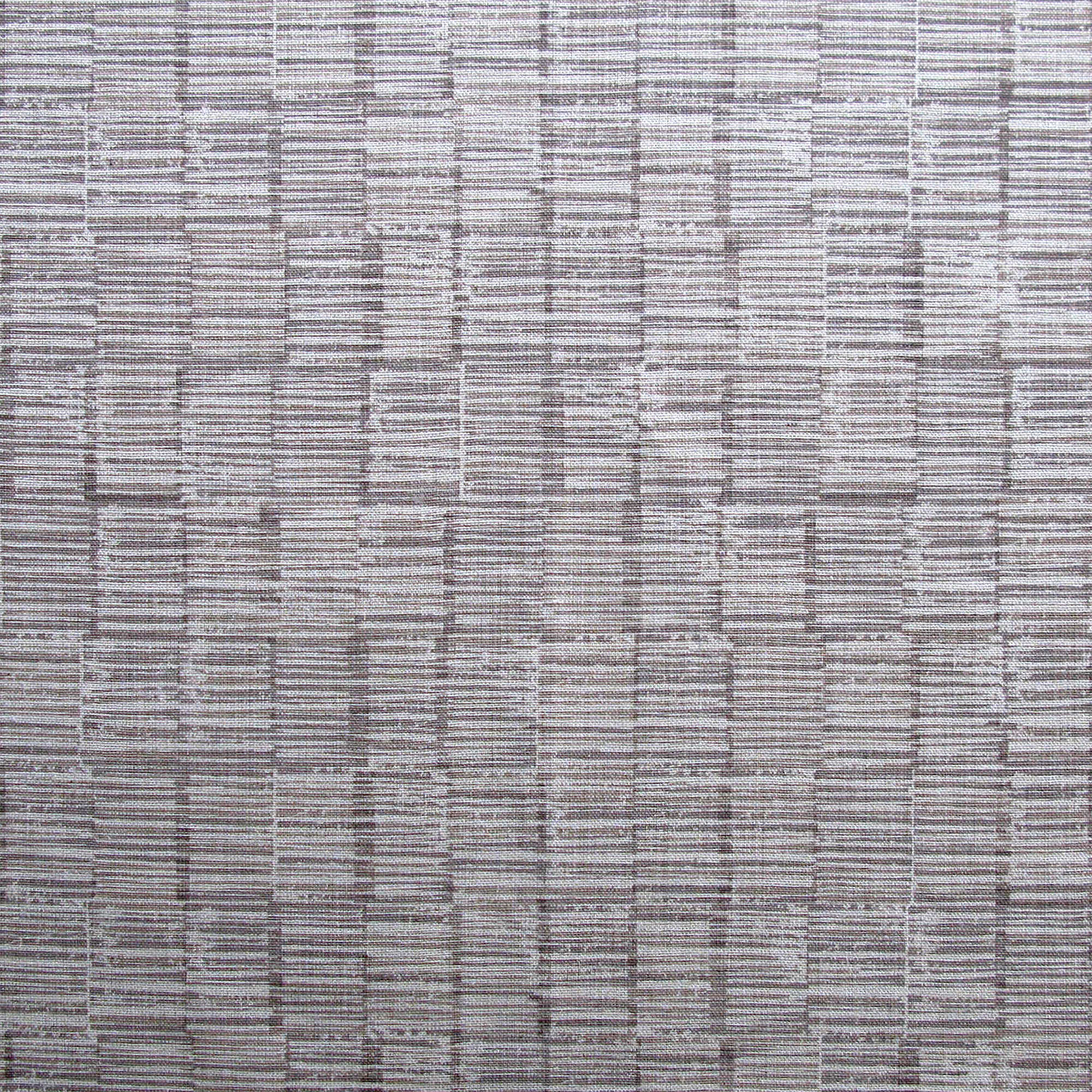 Detail of fabric in a textural grid print in gray on a light gray field.