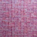 Detail of fabric in a textural grid print in pink and purple on a light gray field.