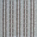 Detail of fabric in a dense tribal stripe pattern in shades of greige, brown and charcoal.