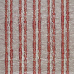 Detail of fabric in a dense tribal stripe pattern in shades of gray and red.