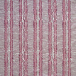 Detail of fabric in a dense tribal stripe pattern in shades of gray, pink and maroon.