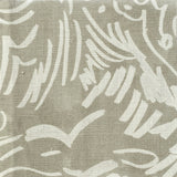 Close-up of fabric in a painterly wave print in white on a greige field.