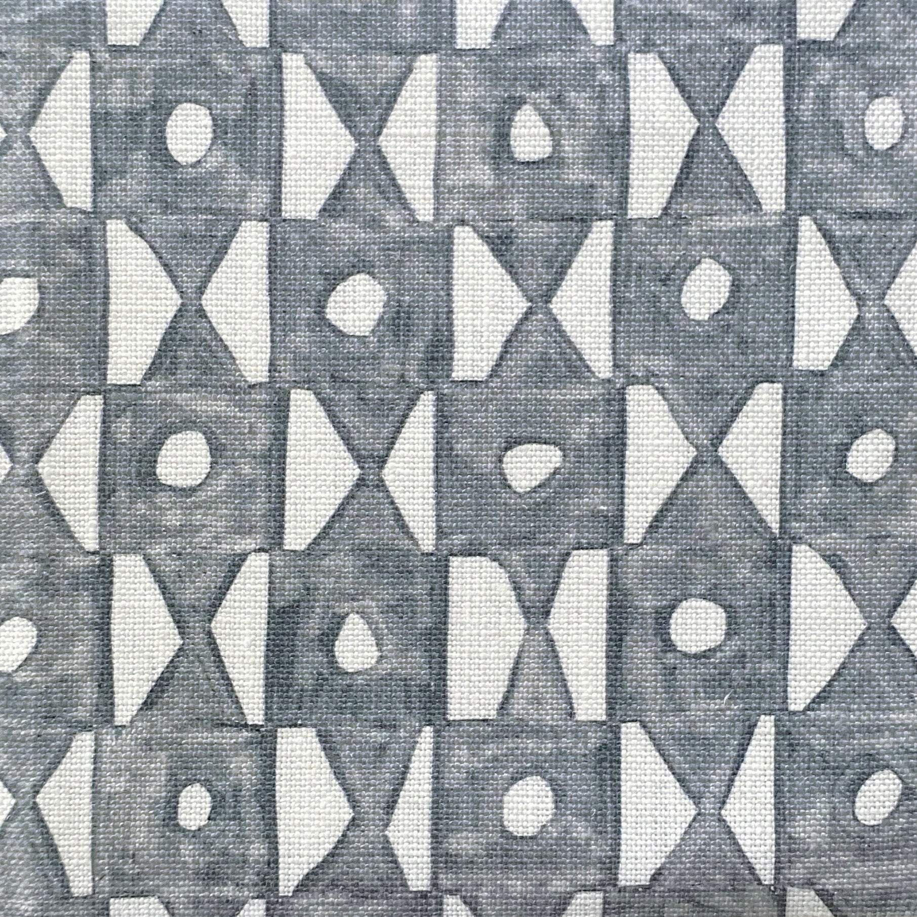 Close-up of fabric in a geometric grid print in navy on a white field.