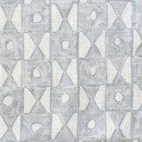 Close-up of fabric in a geometric grid print in light blue on a white field.