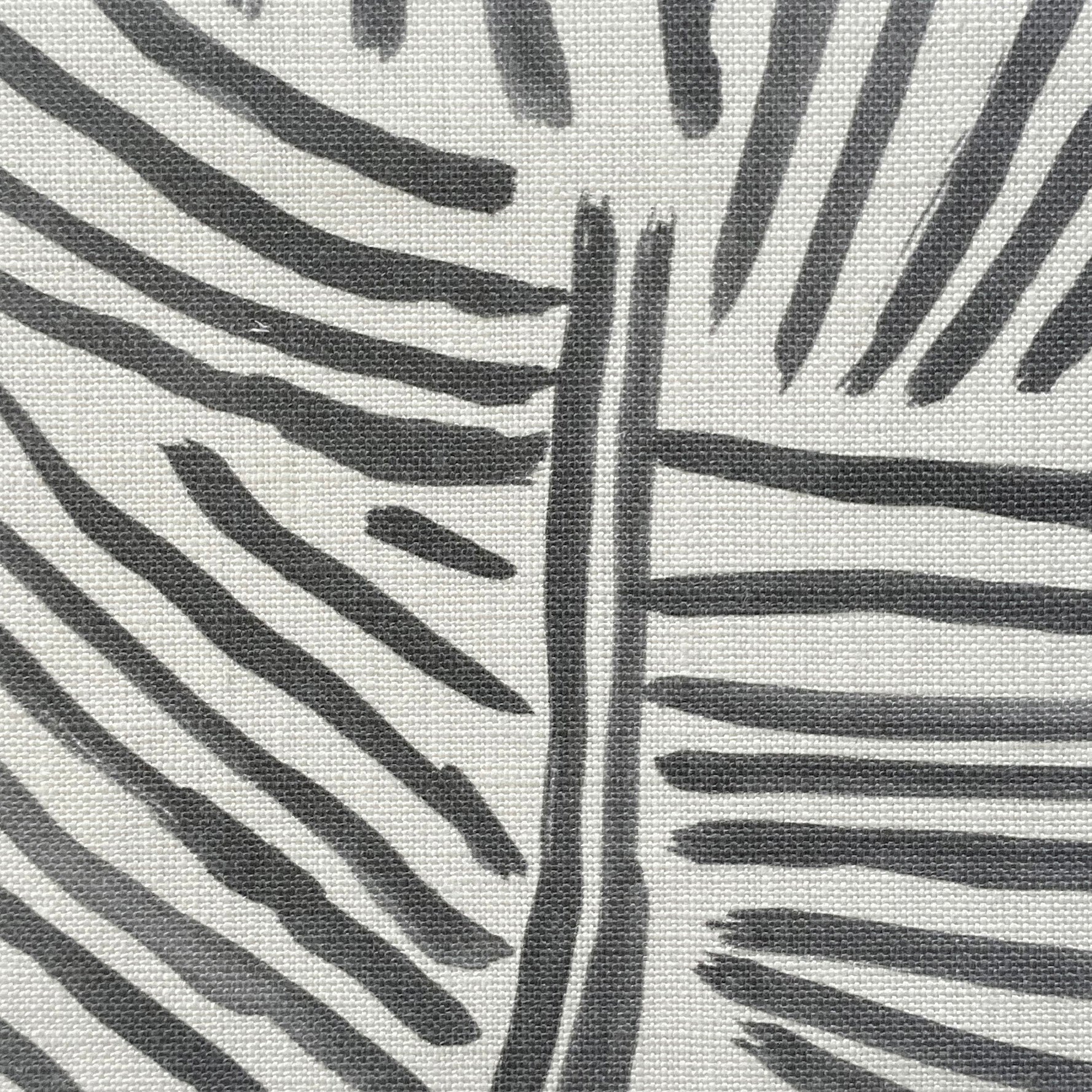 Close-up of fabric in an abstract linear print in black on a white field.