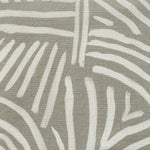 Close-up of fabric in an abstract linear print in white on a sage field.