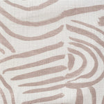 Close-up of fabric in an abstract linear print in blush on a white field.