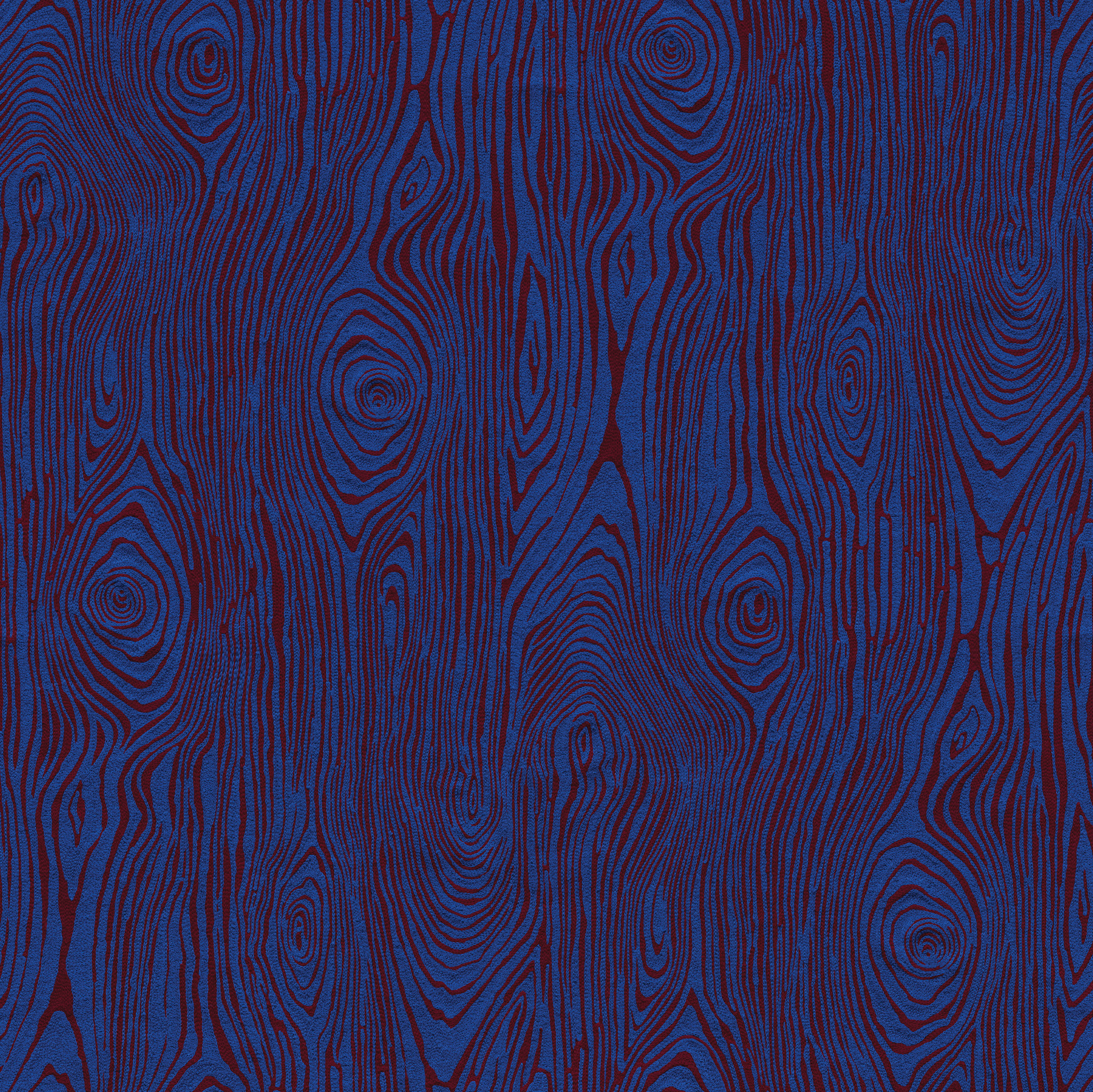 Detail of wallpaper in a textural wood grain print in red on a blue field.