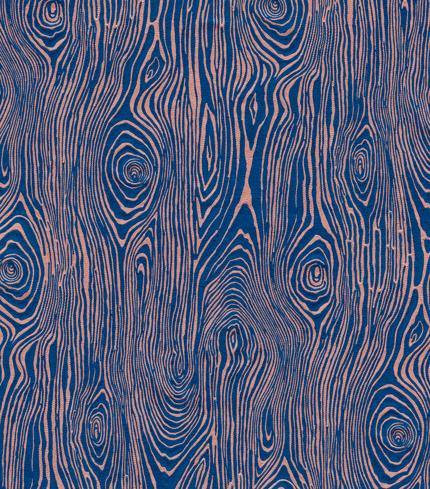 Detail of wallpaper in a textural wood grain print in pink on a blue field.