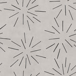 Detail of wallpaper in a playful firework print in black on a greige field.