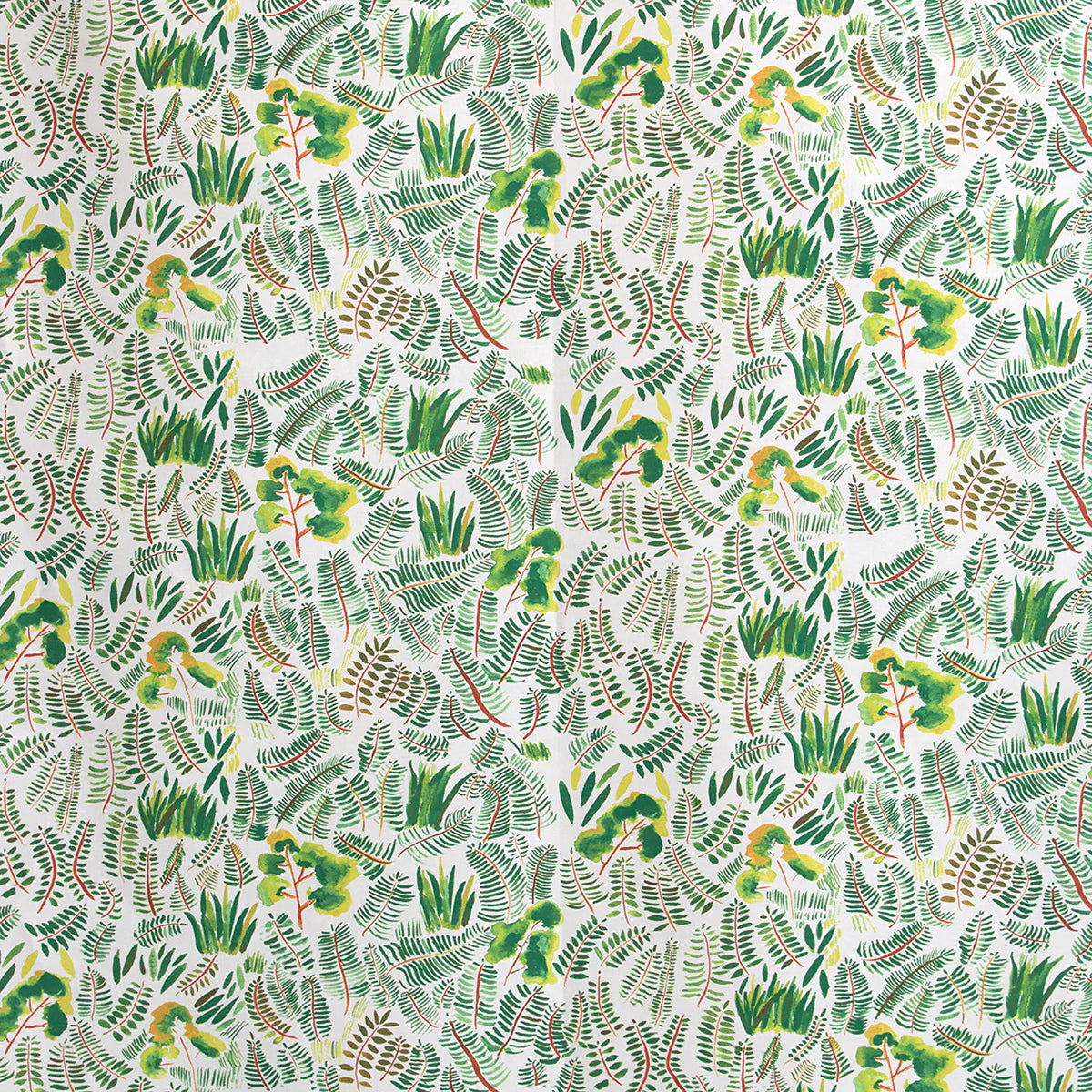 Detail of fabric in a painterly botanical print in shades of green and yellow on a white field.